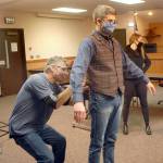 Clallam County Comissioner Mark Ozias, center, is wired with a microphone by sound crewman Eric Soma as producer Ashley Riegle prepares for a taped interview on Friday. (Keith Thorpe/Peninsula Daily News)