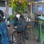 Young Johnson, owner of H2O on the Port Angeles waterfront, chats during an interview with ABC News correspondent Zohreen Shah during an interview on Friday for an upcoming televisiion segment. (Keith Thorpe/Peninsula Daily News)