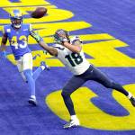 Seattle Seahawks wide receiver Freddie Swain reaches but cant catch a pass in the end zone Sunday during the first half against Rams defender John Johnson III in Inglewood, Calif. (Ashley Landis/The Associated Press)