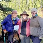 Amputee Dana Lawson, left, celebrates arriving at Deer Lake after a 4-mile trail ride on narrow, steep and rocky terrain aboard horses and mules with friends Sherry Baysinger, center, and Lindsay Leiendecker. (Larry Baysinger)
