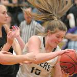 Port Angeles' Myra Walker, right, grabs a rebound from Sequim's LeeAnn Raney, left, and Hannah Wagner during a game last February at Port Angeles High School. (Keith Thorpe/Peninsula Daily News)