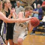 Port Angeles Myra Walker, right, grabs a rebound from Sequims LeeAnn Raney, left, and Hannah Wagner during a game last February at Port Angeles High School. (Keith Thorpe/Peninsula Daily News)