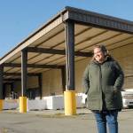 Port Angeles Food Bank Executive Director Emily Dexter stands outside the food bank's new warehouse and distribution center at 632 N. Oakridge Drive near the Port Angeles Walmart. The covered canopy area will become the food bank's drive-thru distribution lane. (Keith Thorpe/Peninsula Daily News)