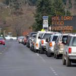 Vehicles lined up throughout a three-hour span to receive free Thanksgiving meals from the Family Holiday Meal Bag distribution program in Carrie Blake Community Park. (Matthew Nash/Olympic Peninsula News Group)