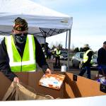 Calvin Barnard, senior vice commander of Carlsborg VFW Post 6787, places a pie in a bag for a family at the Family Holiday Meal Bag distribution. (Matthew Nash/Olympic Peninsula News Group)