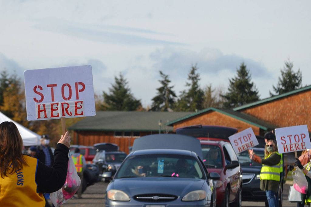 Vehicles lined up from the Albert Haller Playfields to Washington Street to receive food from the Family Holiday Meal distribution program. (Matthew Nash/Olympic Peninsula News Group)