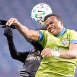 Seattle Sounders defender Nouhou, right, and Los Angeles FC forward Latif Blessing leap to head the ball ball during the second half of an MLS playoff soccer match Tuesday in Seattle. The Sounders won 3-1. (AP Photo/Ted S. Warren)