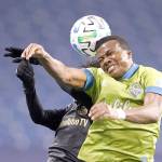 Seattle Sounders defender Nouhou, right, and Los Angeles FC forward Latif Blessing leap to head the ball ball during the second half of an MLS playoff soccer match Tuesday in Seattle. The Sounders won 3-1. (AP Photo/Ted S. Warren)