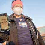 Nurse Jessica Franz, shows a photo of her mother-in-law, Elaine Franz, outside Olathe Medical Center after working the graveyard shift Thursday in Olathe, Kan. Elaine Franz died Nov. 10, one day before her 78th birthday, after contracting COVID-19. (Charlie Riedel/The Associated Press)