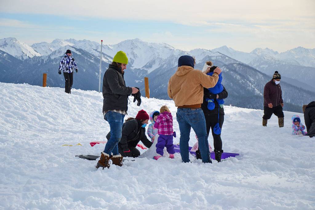 A young family plays in the Small Childrens Snowplay Area at Hurricane Ridge on Friday, Nov. 27, 2020. (Laura Foster/Peninsula Daily News)