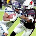 Seattle Seahawks running back Chris Carson (32) runs as Arizona Cardinals outside linebacker De'Vondre Campbell defends during the first half of an NFL football game, Sunday, Oct. 25, 2020, in Glendale, Ariz. (AP Photo/Rick Scuteri)