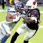 Seattle Seahawks running back Chris Carson (32) runs as Arizona Cardinals outside linebacker DeVondre Campbell defends during the first half of an NFL football game, Sunday, Oct. 25, 2020, in Glendale, Ariz. (AP Photo/Rick Scuteri)