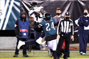 Seattle Seahawks' DK Metcalf (14) catches a pass against Philadelphia Eagles' Darius Slay (24) during the second half of an NFL football game, Monday, Nov. 30, 2020, in Philadelphia. (AP Photo/Derik Hamilton)