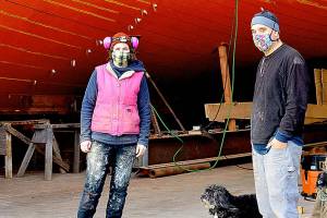 The Western Flyer, made famous in John Steinbeck's "The Log from the Sea of Cortez," is being restored at the Shipwrights Cooperative in Port Townsend with Ginny Wilson, Tim Lee and Tuff the dog on the crew. A tour of the project is one of the items in the Jefferson County Historical Society's AHA Auction wrapping up this weekend. (Diane Urbani de la Paz/Peninsula Daily News)