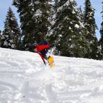 A snowboarder hits a jump on a ski trail at Hurricane Ridge on Friday, Nov. 27, 2020. (Laura Foster/Peninsula Daily News)
