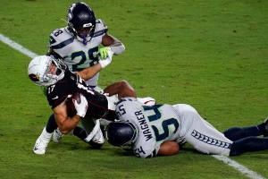 Arizona Cardinals wide receiver Andy Isabella (17) is hit by Seattle Seahawks middle linebacker Bobby Wagner (54) during the second half of an NFL football game, Sunday, Oct. 25, 2020, in Glendale, Ariz. (AP Photo/Ross D. Franklin)