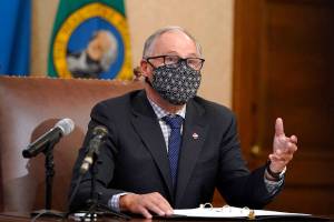 Washington Gov. Jay Inslee speaks during a news conference, Monday, Nov. 30, 2020, at the Capitol in Olympia, Wash. The state announced a new statewide coronavirus exposure notification program Monday that uses smartphone technology in the ongoing effort to prevent the spread of COVID-19. People with Apple iPhones can now enable the 'exposure notifications' feature that is already in their phone's settings, and Android devices can download the app. Use of the service is voluntary and users can opt-out at any time. (AP Photo/Ted S. Warren)