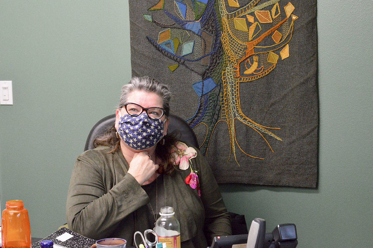 Siobhan Canty, CEO of the Jefferson Community Foundation, works with the Housing Solutions Network in her new office space in Port Townsend. After the foundation was evicted from its Port Hadlock office, Edensaw Woods donated the Julian Street space. (Diane Urbani de la Paz/Peninsula Daily News)