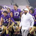 Washington coach Jimmy Lake celebrates with the team after Washington defeated Utah 24-21 in an NCAA college football game Saturday, Nov. 28, 2020, in Seattle. (AP Photo/Ted S. Warren)