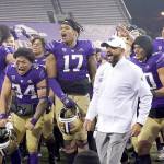 Washington coach Jimmy Lake celebrates with the team after Washington defeated Utah 24-21 in an NCAA college football game Saturday, Nov. 28, 2020, in Seattle. (Ted S. Warren/Associated Press)