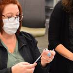 Nurse coordinator Erin Wallner, left, and clinical manager Jaimie Hoobler prepare the first COVID vaccines at Jefferson Healthcare hospital Wednesday, Dec. 16, 2020. (Diane Urbani de la Paz/Peninsula Daily News)
