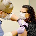 Nurse Jess Cigalotti administers the North Olympic Peninsulas first COVID-19 vaccine Wednesday, Dec. 16, 2020, to Dr. Tracie Harris, an internist and hospitalist who cares for COVID patients at Jefferson Healthcare hospital. (Diane Urbani de la Paz/Peninsula Daily News)