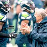 Seattle Seahawks head coach Pete Carroll claps as player warmup around him before an NFL football game against the New York Jets, Sunday, Dec. 13, 2020, in Seattle. The Seahawks won 40-3. (AP Photo/Stephen Brashear)