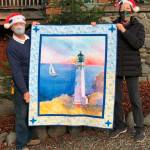 Beverly Nelson receives the Sequim Bay Yacht Clubs 2020 hospice quilt raffle in early December from commodore Jerry Fine. (Submitted photo)