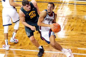 Gonzaga guard Jalen Suggs (1) drives the baseline against Iowa defender Luka Garza (55) during the second half of an NCAA college basketball game Saturday, Dec. 19, 2020 in SIoux Falls, S.D. (AP Photo/Josh Jurgens)