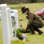 Lance Cpl. Holly Rowan, a U.S. Marine Corps veteran, lays a ceremonial wreath at Saturdays Wreaths Across America event at Sequim View Cemetery. (Michael Dashiell/Olympic Peninsula News Group)