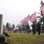 Members of the Clallam County Legion Riders Post 29 create a flag line as a patriotic backdrop to the Wreaths Across America event held. Dec. 19 at Sequim View Cemetery. (Michael Dashiell/Olympic Peninsula News Group)