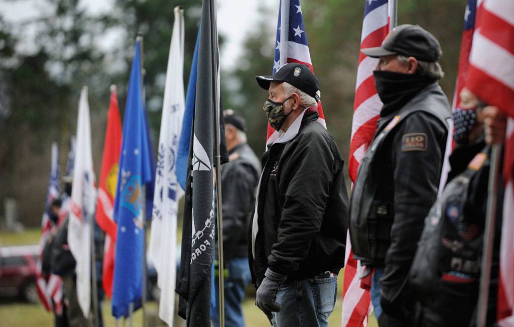 Members of the Clallam County Legion Riders Post 29 create a flag line as a patriotic backdrop to the Wreaths Across America event held Dec. 19 at Sequim View Cemetery. (Michael Dashiell/Olympic Peninsula News Group)