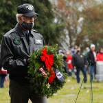 Col. Randy Roberts (U.S. Air Force, retired) prepares to lay a ceremonial wreath for U.S. military prisoners of war and missing in action during Saturday's Wreaths Across America event at Sequim View Cemetery. (Michael Dashiell/Olympic Peninsula News Group)