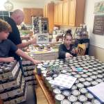The family of Leslee Francis, Olympic Peninsula Healthy Communities Coalition executive director, son, Austin, 11, husband, Doug, and daughter ,Savannah, 13, help arrange 350 jars of kindness for disitribution to Clallam County behavioral health workers. (Courtesy photo)