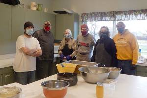 Feeding 5000 provided Christmas lunches to go on Tuesday. Pictured are, from left, Todd McGrail, Eugene Fraker, Doris Villarreal. Mark Calamar, Sherry Schaaf and Pastor Bob Schwartz in the kitchen at the Forks Community Center. Feeding 5000 is a nonprofit organization funded by the community and local churches. It serves free meals each Tuesday. (Christi Baron/Olympic Peninsula News Group)