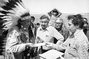 FILE - In this May 5, 1973 file photo Hank Adams, right, permanent representative of the Indians Trial of Broken Treaties presents letter from the White House to traditional Sioux Chief Frank Fools Crow, left, at border of Pine Ridge Reservation in Scenic,. S.D.  Henry “Hank” Adams, Assiniboine-Sioux, died Dec. 21, 2020 at St. Peter’s Hospital in Olympia, Wash., according to the Northwest Indian Fisheries Commission. Influential Native American rights advocate and author Vine Deloria Jr. called Adams the "most important Indian" because he was involved with nearly every major event in American Indian history from the 1960s forward. (AP Photo, File)