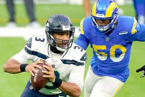 Seattle Seahawks quarterback Russell Wilson, left, gets some pressure from Los Angeles Rams outside linebacker Samson Ebukam during an NFL football game Sunday, Nov. 15, 2020, in Inglewood, Calif. (AP Photo/Ashley Landis)