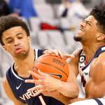 Virginia guard Jabri Abdur-Rahim (1) and Gonzaga guard Aaron Cook (4) wrestle for control of the ball during the second half of an NCAA college basketball game Saturday, Dec. 26, 2020, in Fort Worth, Texas. Gonzaga won 98-75. (AP Photo/Ron Jenkins)