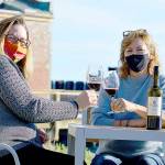 Tasting room lead Heidi Haney, left, and co-owner Karle Coppenrath await the day when the restored Port Townsend Vineyards Vintage Downtown building and plaza can host the gatherings it's designed for. (Diane Urbani de la Paz/Peninsula Daily News)