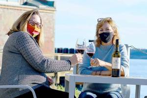 Tasting room lead Heidi Haney, left, and co-owner Karle Coppenrath await the day when the restored Port Townsend Vineyards Vintage Downtown building and plaza can host the gatherings it's designed for. (Diane Urbani de la Paz/Peninsula Daily News)