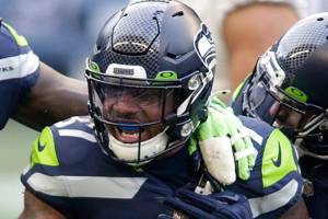 Seattle Seahawks free safety Quandre Diggs (37) reacts with defensive end Benson Mayowa (95) and linebacker Bobby Wagner (54) after Diggs intercepted a pass during the first half of an NFL football game against the Los Angeles Rams, Sunday, Dec. 27, 2020, in Seattle. (AP Photo/Scott Eklund)