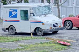 Wind snapped a stop sign post at Lawrence and Van Buren streets on Wednesday in Uptown Port Townsend. The powerful gusts knocked power out for nearly 1,000 Jefferson Public Utility District customers throughout the morning. (Diane Urbani de la Paz/Peninsula Daily News)