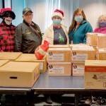 Helga Greer, left, Randy Yard, Charlie Johnson, Maura Mattson, Jennifer Petty, Valerie Brooks and Cat Yard, members of Sequim Elks Lodge No. 2642 and staff of the Clallam County Juvenile and Family Services child advocate program, pause in delivering Christmas meals to foster families. The lodge used a $3,500 Beacon Grant from the Elks National Foundation to purchase 50 complete dinners for the foster families in the program.
