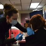 Nurse Kelly Bower with Jamestown Family Health Clinic provides a COVID-19 vaccine to volunteer EMT Sandy Boudrou at the Clallam County Fire District 3 headquarters on Tuesday. (Matthew Nash/Olympic Peninsula News Group)