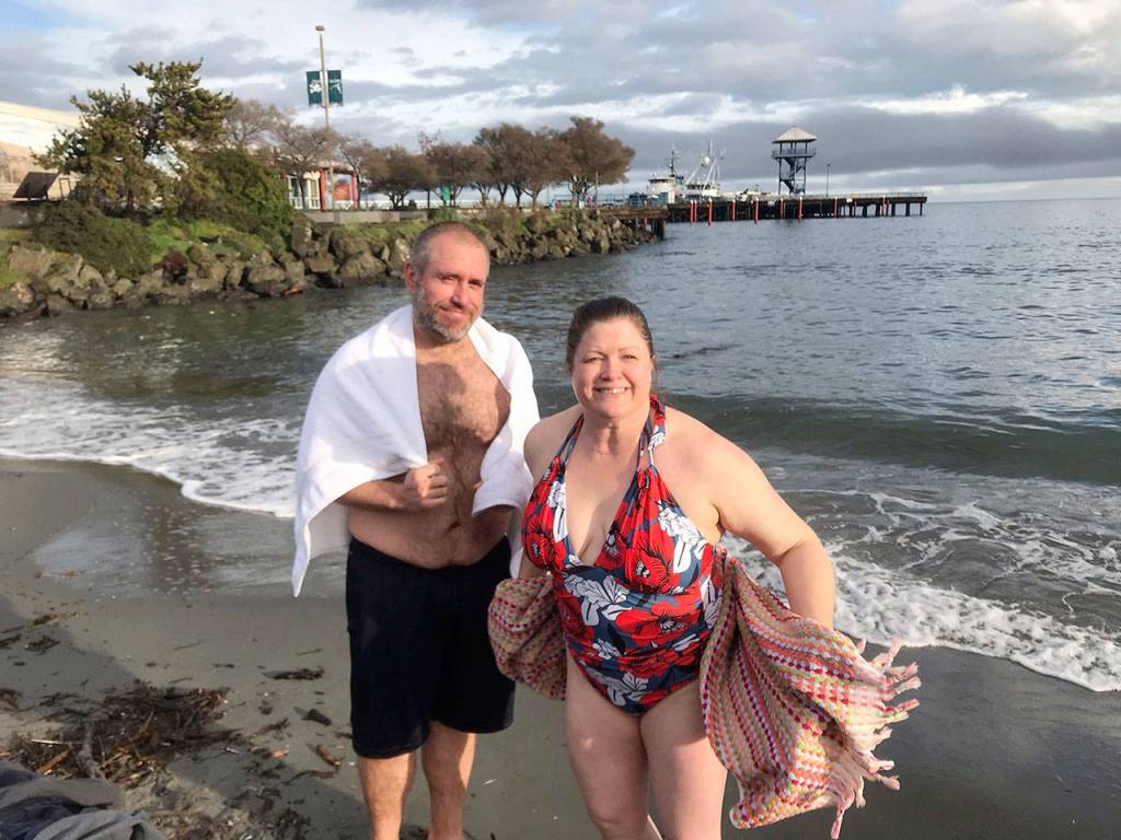 Kirk and Tresa Sehlmeyer of Port Angeles took a traditional New Years Day dip Friday into Port Angeles Harbor from Hollywood Beach. (Paul Gottlieb/Peninsula Daily News)