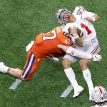 Ohio State quarterback Justin Fields gets hit by Clemson linebacker James Skalski during the first half of the Sugar Bowl Friday night in New Orleans. Skalski was ejected from the game for targeting. (AP Photo/Butch Dill)