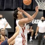 Washington State center Dishon Jackson (21) reaches for a rebound against Arizona in the first half Saturday in Pullman. Arizona won 86-82 in double overtime to hand the Cougars their first loss of the year. (Dean Hare/Associated Press)
