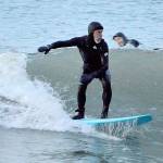 Piper Dunlap of Port Townsend rides the cold waves at North Beach County Park, where he and four other surfers stayed Sunday evening until it was too dark to see. (Diane Urbani de la Paz/Peninsula Daily News)