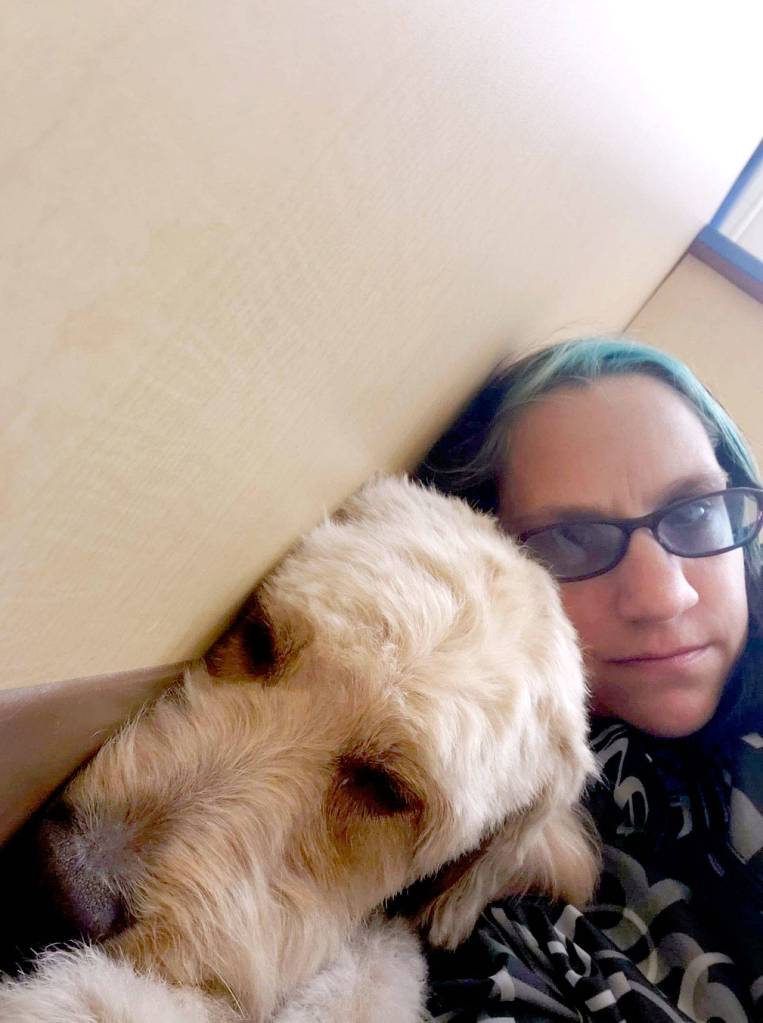 Apryle Schondelmeyer comforts a clients dog during a grooming session at PetSense in Port Angeles. Schondelmeyer was the lead groomer at the shop.