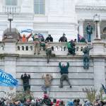 Supporters of President Donald Trump climb the west wall of the the U.S. Capitol on Wednesday in Washington, D.C. (Jose Luis Magana/The Associated Press)